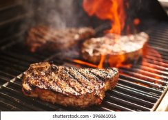steaks-cooking-over-flaming-grill-260nw-396861016.jpg